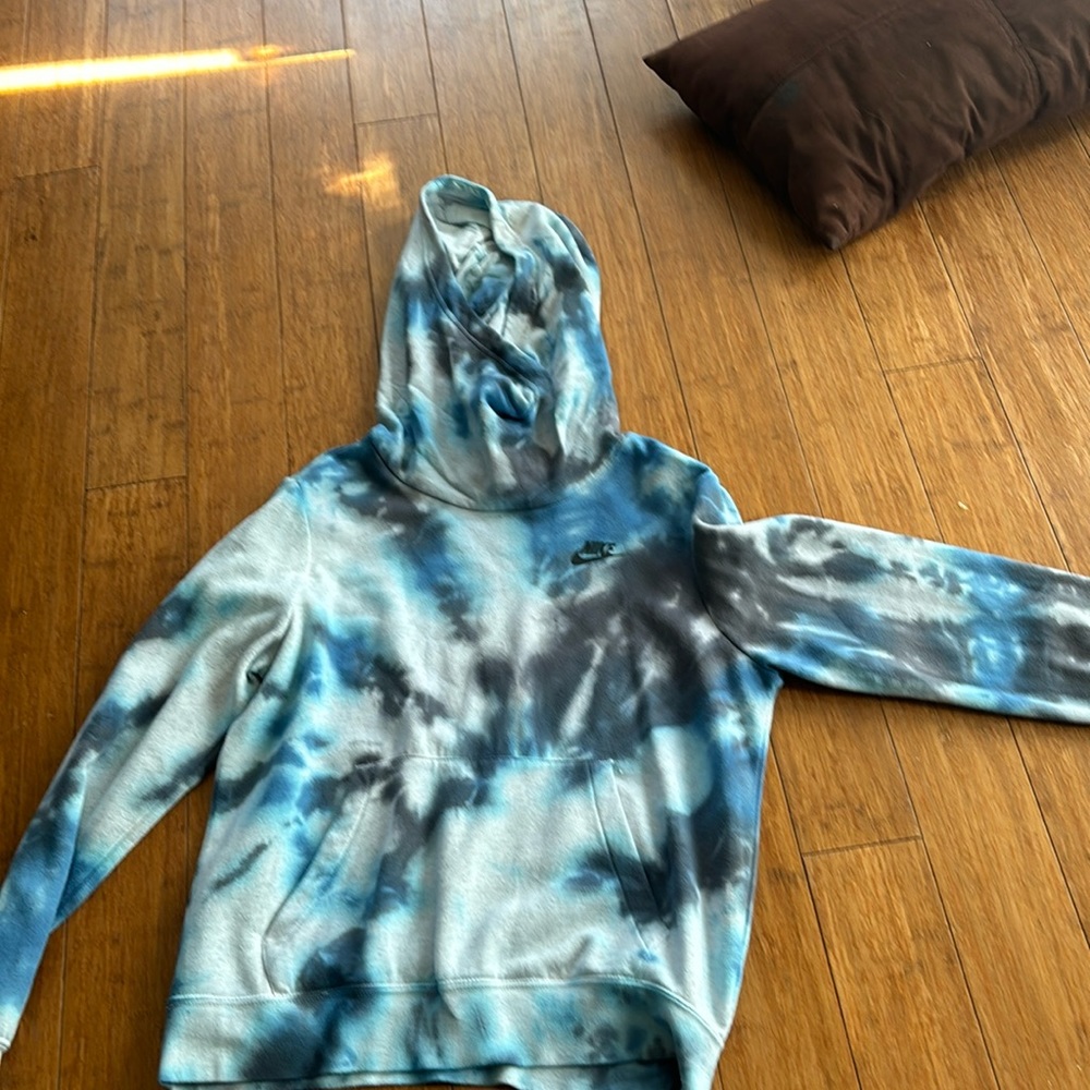 This is a blue and black tie dye Nike hoodie size S.